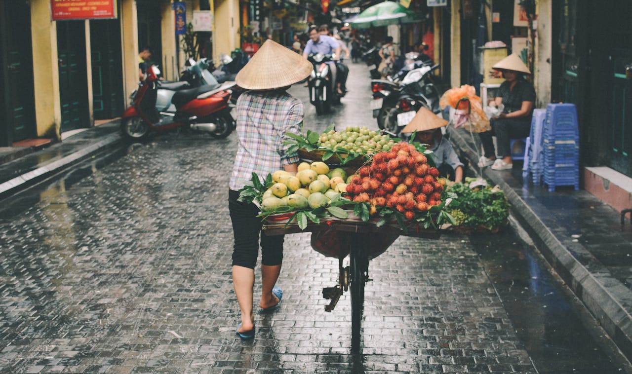 About A woman sells fresh fruits in a Đống Đa street market, Hanoi, Vietnam.